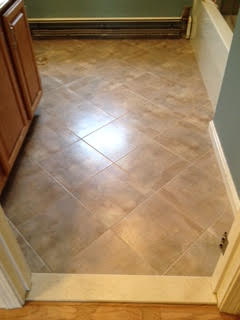 Beige square tile flooring for bathroom installed at angle